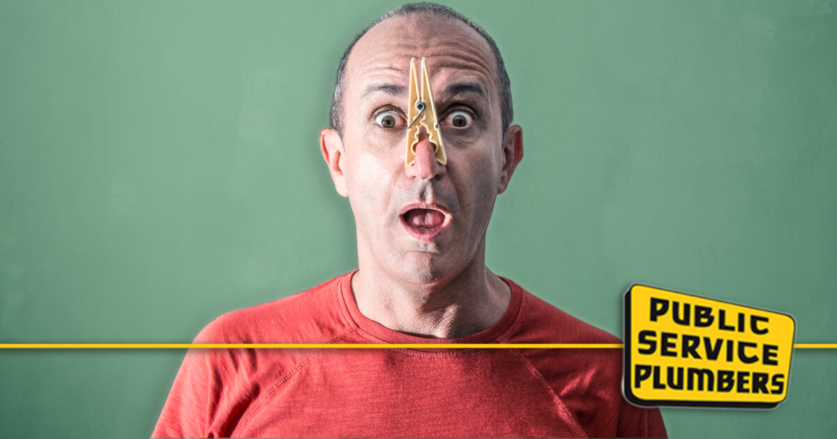 DIY drain odor elimination featured image featuring man with clothespin on nose