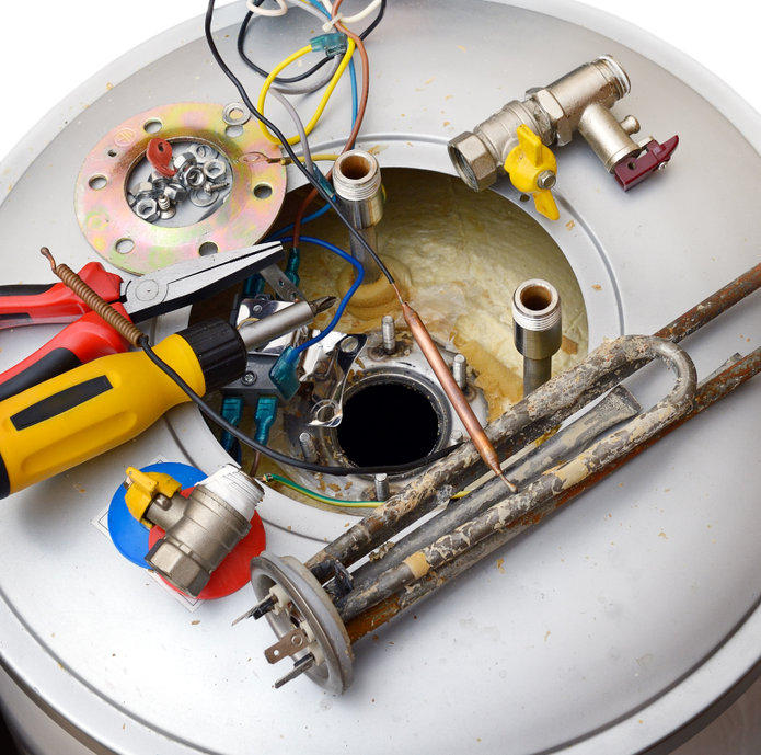 Gas Water Heater Services in Dallas, TX - Public Service Plumbers - Dallas TX A picture of the top of a water heater partially disassembled with tools laying next to them, indicating repair being performed on the water heater,